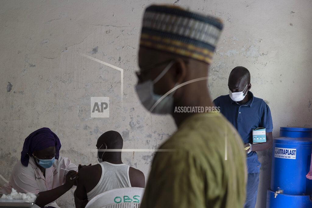 Leo Correa CORRECTS LOCATION A health worker administers a dose of Janssen Johnson & Johnson COVID-19 vaccine at Dakar's Medina neighborhood, Senegal, Wednesday, July 28, 2021. In the midst of a third wave of the coronavirus pandemic, with many countries on the cusp, African health officials are racing to vaccinate populations that had before been reluctant or unable to access vaccines. (AP Photo/Leo Correa)