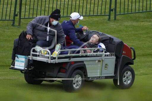 Actor Tom Felton is helped after collapsing on the 18th hole during a practice day at the Ryder Cup at the Whistling Straits Golf Course Thursday, Sept. 23, 2021, in Sheboygan, Wis. (AP Photo/Ashley Landis)