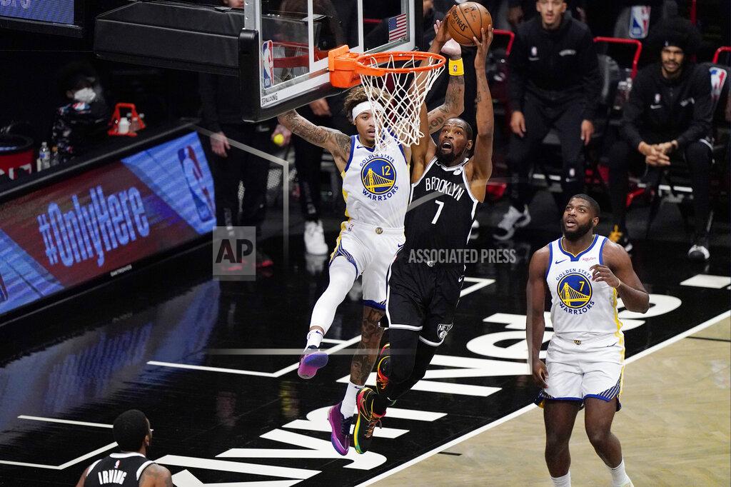 Kathy Willens Brooklyn Nets forward Kevin Durant (7) shoots as Golden State Warriors forward Kelly Oubre Jr. (12) defends with Golden State Warriors forward Eric Paschall (7) looking on from the floor during the first quarter of an opening night NBA basketball game, Tuesday, Dec. 22, 2020, in New York. (AP Photo/Kathy Willens)