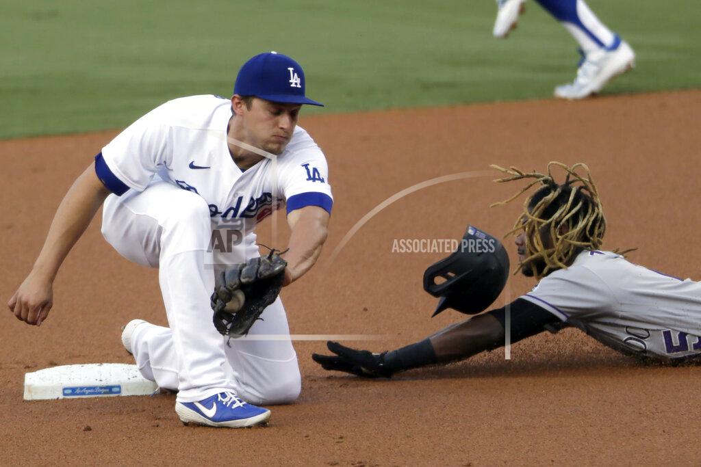 Alex Gallardo Colorado Rockies' Raimel Tapia, right, steals second base as Los Angeles Dodgers shortstop Corey Seager catches the ball, but cannot apply the tag in time during the first inning of a baseball game in Los Angeles, Saturday, Aug. 22, 2020. (AP Photo/Alex Gallardo)
