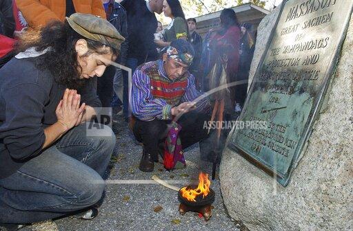 FILE- Supporters of Native Americans pause following a prayer during the 38th National Day of Mourning at Coles Hill in Plymouth, Mass., on Nov. 22, 2007. Denouncing centuries of racism and mistreatment of Indigenous people, members of Native American tribes from around New England will gather on Thanksgiving 2021 for a solemn National Day of Mourning observance. (AP Photo/Lisa Poole, File)