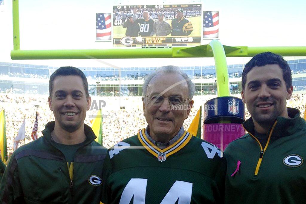 Uncredited In this October 2012 photo provided by Karen Gooch, former Green Bay Packers football player Bobby Dillon is shown flanked by his grandsons Dillon Gooch, left and Weston Gooch during ceremonies at Lambeau Field in Green Bay, Wisc. Dillon passed away at age 89 in August 2019, five months before he was selected for the Hall of Fame as part of the centennial class. (Karen Gooch via AP)