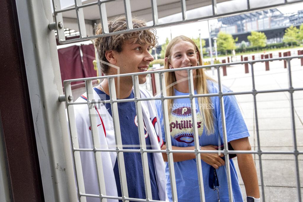 Laurence Kesterson Fans stand at the locked gate of Citizens Bank Park after the baseball game between the Philadelphia Phillies and Washington Nationals was postponed due to COVID-19 issues among the Nationals, Wednesday, July 28, 2021, in Philadelphia. (AP Photo/Laurence Kesterson)