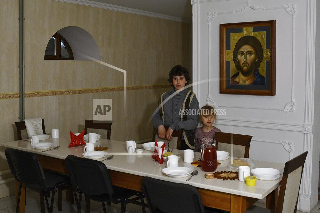 Andriy Andriyenko Children wait for a meal in the Orthodox Skete in honor of St. John of Shanghai in Adamivka, near Slovyansk, Donetsk region, Ukraine, Tuesday, May 10, 2022. (AP Photo/Andriy Andriyenko)