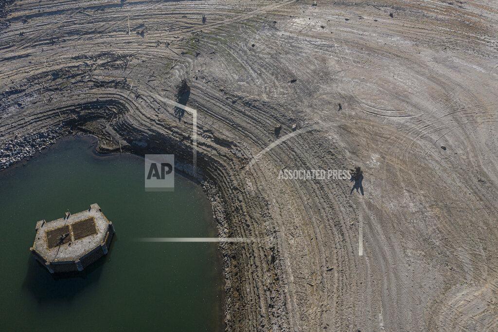 Nathan Howard The lake bed of the Wickiup Reservoir is exposed by drought conditions that left the reservoir at 1% capacity on Wednesday, Sept. 1, 2021, near La Pine, Ore. The stark contrast between the water haves and have-nots two hours southeast of Portland has brought new urgency to efforts to share the resource. Proposals to create "water banks" or "water markets" would allow farmers with excess water to "lease" it to those in need. (AP Photo/Nathan Howard)
