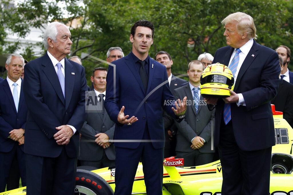 Patrick Semansky Driver Simon Pagenaud, center, speaks in front of team owner Roger Penske, left, and President Donald Trump on the South Lawn at the White House, Monday, June 10, 2019, in Washington during an event to honor Team Penske for the 2019 Indianapolis 500 win. (AP Photo/Patrick Semansky)
