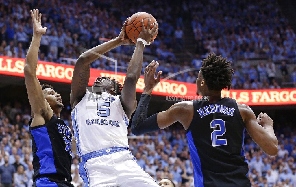 Gerry Broome North Carolina's Nassir Little (5) drives to the basket as Duke's Cam Reddish (2) and Javin DeLaurier, left, defend during the first half of an NCAA college basketball game in Chapel Hill, N.C., Saturday, March 9, 2019. (AP Photo/Gerry Broome)