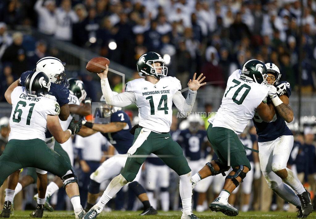 Chris Knight FILE - In this Oct. 13, 2018, file photo, Michigan State quarterback Brian Lewerke (14) throws a pass against Penn State during the second half of an NCAA college football game in State College, Pa. Whether the priority is secrecy or modesty, Michigan State has said little about any changes on the offensive side of the ball, but once the games start, there will be nowhere to hide. The Spartans are under pressure--from their own fans, first and foremost--to produce. (AP Photo/Chris Knight, File)