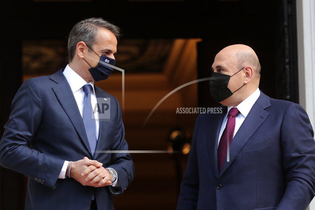 Petros Giannakouris Greece's Prime Minister Kyriakos Mitsotakis, left, welcomes Russian Prime Minister Mikhail Mishustin at Maximos Mansion in Athens, Wednesday, March 24, 2021. Greece is kicking off two days of celebrations to mark the bicentenary of the start of the country's war of independence, although events are far more muted than originally planned due to the coronavirus pandemic. (AP Photo/Petros Giannakouris)