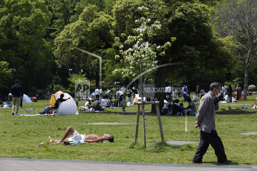 Kiichiro Sato In this April 29, 2020 photo, Shiba Park is packed with families with small children day camping in tents on the first day of the "Golden Week" holidays in Tokyo. Under Japan's coronavirus state of emergency, people have been asked to stay home. Many are not. Some still have to commute to their jobs despite risks of infection, while others are dining out, picnicking in parks and crowding into grocery stores with scant regard for social distancing. (AP Photo/Kiichiro Sato)