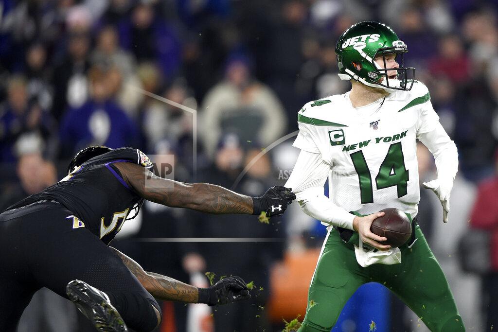 Gail Burton Baltimore Ravens defensive end Jihad Ward, left, grabs at the jersey of New York Jets quarterback Sam Darnold (14) during the first half of an NFL football game, Thursday, Dec. 12, 2019, in Baltimore. (AP Photo/Gail Burton)