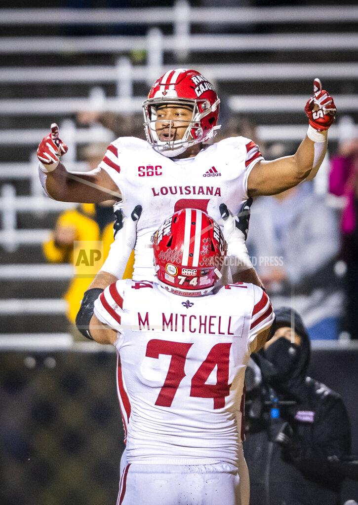 Andrew Dye Louisiana running back Trey Ragas, top, celebrates after running for a touchdown against Appalachian State with offensive lineman Max Mitchell (74) during an NCAA college football game Friday, Dec. 4, 2020, in Boone, N.C. (Andrew Dye/The Winston-Salem Journal via AP)