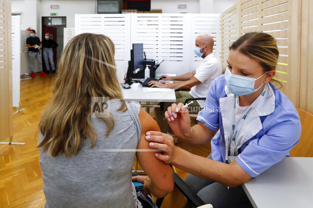 Uncredited A person is administered the COVID-19 vaccine in Ljubljana, Friday, Sept. 10, 2021. Slovenia has introduced a mandatory anti-COVID vaccination for all civil service employees, further tightening anti-coronavirus measures that have triggered a major riot in the small Alpine state. The measure passed Friday Sept. 17, 2021 says that all state administration employees will need to be vaccinated with one shot by Oct. 1 and by Nov. 1 with the second, unless it's the one-dose Johnson & Johnson vaccine. (AP Photo)