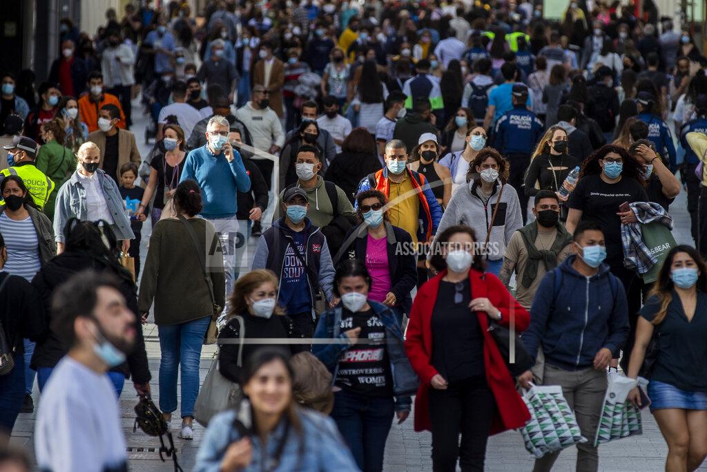 Manu Fernandez People wearing face masks to protect against the spread of coronavirus walk in downtown Madrid, Spain, Wednesday, March 31, 2021. Spain is bracing for another potential sharp increase in coronavirus cases. And with the vaccine rollout being outpaced by the new more contagious variant of the virus, authorities are asking for citizens to intensify their precautions to "buy time" for the shots to arrive. (AP Photo/Manu Fernandez)