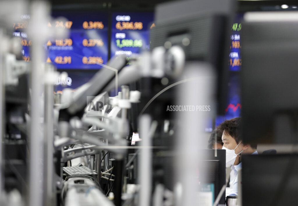 Lee Jin-Man A currency trader watches computer monitors at the foreign exchange dealing room in Seoul, South Korea, Thursday, April 29, 2021. Asian shares rose Thursday and U.S. futures also were higher after President Joe Biden delivered a speech to Congress that outlined ambitious plans for jobs creating spending on early education, child care and other public services.(AP Photo/Lee Jin-man)
