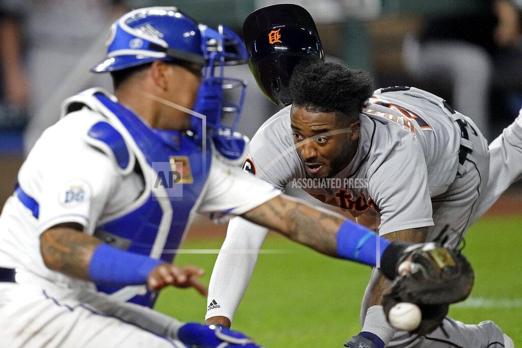 Detroit Tigers' Niko Goodrum beats the throw to Kansas City Royals catcher Salvador Perez to score on a sacrifice fly by Eric Haase during the seventh inning of a baseball game Friday, Sept. 25, 2020, in Kansas City, Mo. (AP Photo/Charlie Riedel)