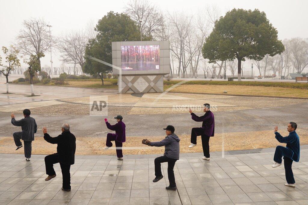 Ng Han Guan Residents practice tai chi at a park in Wuhan in central China's Hubei Province on Saturday, Jan. 23, 2021. A year after it was locked down to contain the spread of coronavirus, the central Chinese city of Wuhan has largely returned to normal, even as China continues to battle outbreaks elsewhere in the country. (AP Photo/Ng Han Guan)