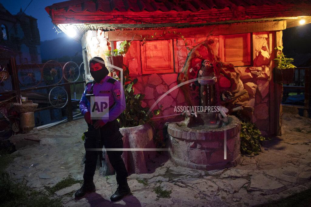 Rodrigo Abd A policeman stands guard at the entrance of the mission and drug rehab center run by Friar Leopoldo Serrano, in Mission San Francisco de Asis, Honduras, Thursday, June 24, 2021. Father Serrano’s message is not widely popular. He has sought protection for his mission. (AP Photo/Rodrigo Abd)