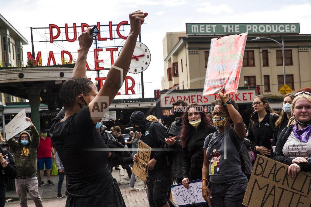 Amanda Snyder Protesters continue past Pike Place Market during the #SeattleJusticeForGeorgeFloyd march on Saturday, June 6, 2020, in Seattle, Washington. The death of George Floyd at the hands of police last month in Minneapolis has sparked nationwide protests for police reform. (Amanda Snyder/The Seattle Times via AP)