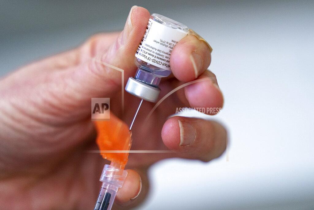 Jonathan Hayward In this Saturday, April 10, 2021 photo, a syringe is loaded with the Pfizer-BioNTech COVID-19 vaccine at a clinic in Richmond, British Columbia, Canada. On Wednesday, May 5, 2021, Canada’s health regulator authorized the Pfizer vaccine for ages 12 and older. (Jonathan Hayward/The Canadian Press via AP)