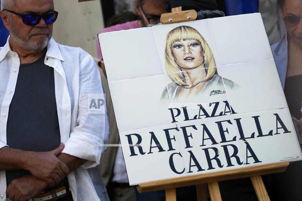 Bernat Armangue Italian choreographer Sergio Japino, left, stands next to a plaque of late Italian artist Raffaella Carra during the inauguration of a square dedicated to the Italian television's entertainer in Madrid, Wednesday, July 6, 2022. (AP Photo/Bernat Armangue)