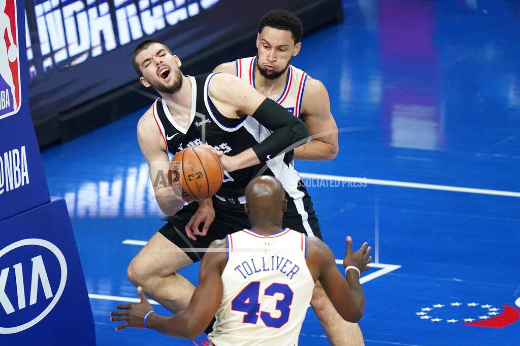 Matt Slocum Los Angeles Clippers' Ivica Zubac center, tries to pass between Philadelphia 76ers' Ben Simmons, top, and Anthony Tolliver during the second half of an NBA basketball game, Friday, April 16, 2021, in Philadelphia. (AP Photo/Matt Slocum)