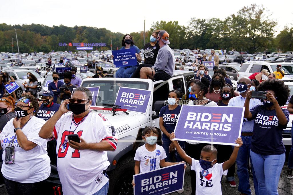 Andrew Harnik People listen during a drive-in rally for Democratic presidential candidate former Vice President Joe Biden at Cellairis Amphitheatre in Atlanta, Tuesday, Oct. 27, 2020. (AP Photo/Andrew Harnik)