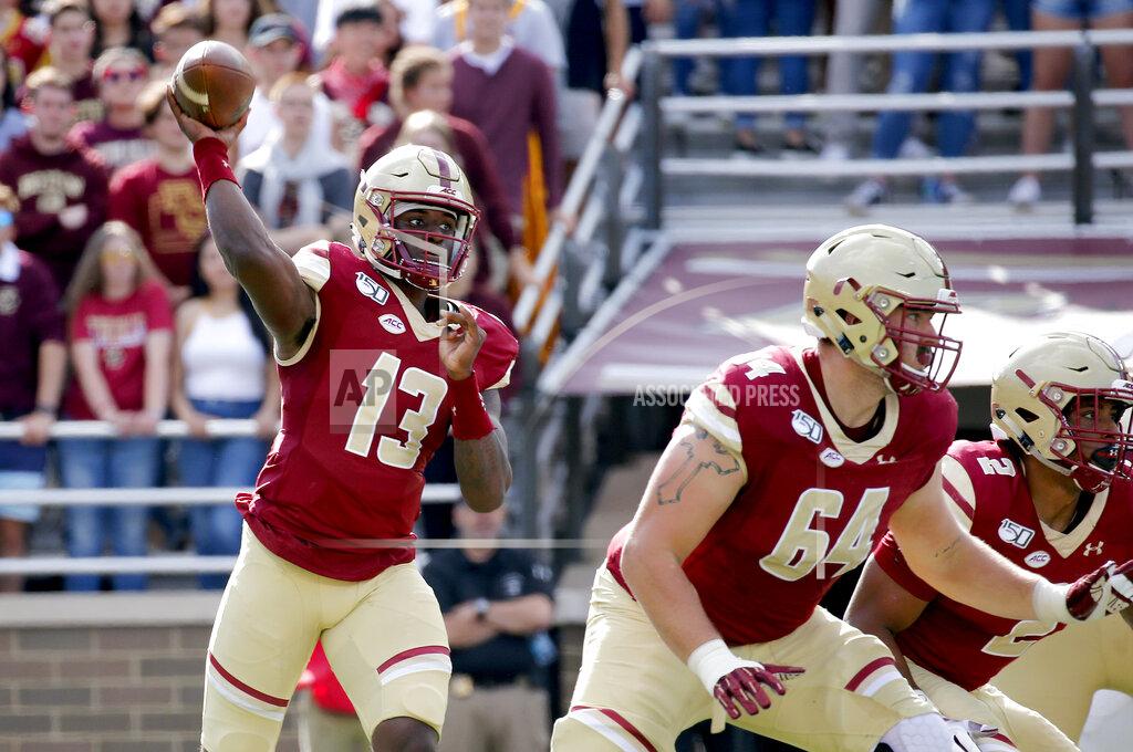 Mary Schwalm Boston College quarterback Anthony Brown (13) looks to pass as Ben Petrula (64) and AJ Dillon (2) block during the first half of an NCAA college football game, Saturday, Sept. 7, 2019, in Boston. (AP Photo/Mary Schwalm)
