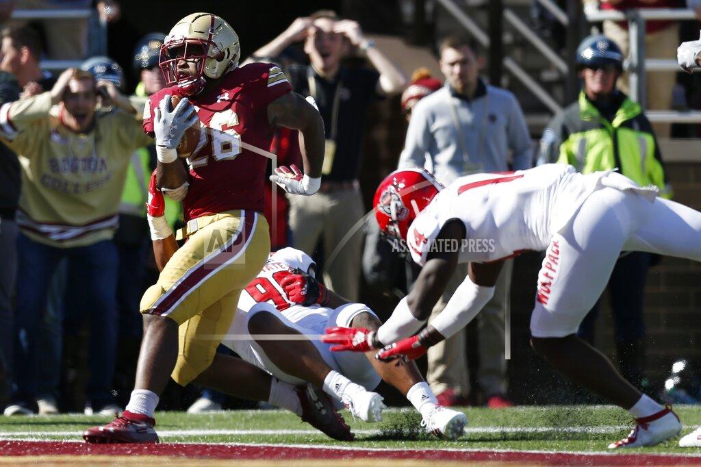 Michael Dwyer Boston College running back David Bailey (26) scores a touchdown against North Carolina State defensive end Savion Jackson (90) and safety De'Von Graves (14) during the first half of an NCAA college football game in Boston, Saturday, Oct. 19, 2019. (AP Photo/Michael Dwyer)