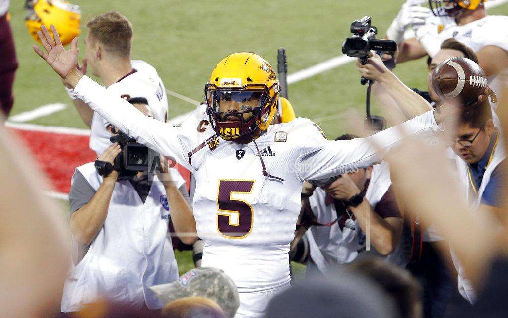 Rick Scuteri Arizona State quarterback Manny Wilkins celebrates with the fans after defeating Arizona in an NCAA college football game, Saturday, Nov. 24, 2018, in Tucson, Ariz. (AP Photo/Rick Scuteri)