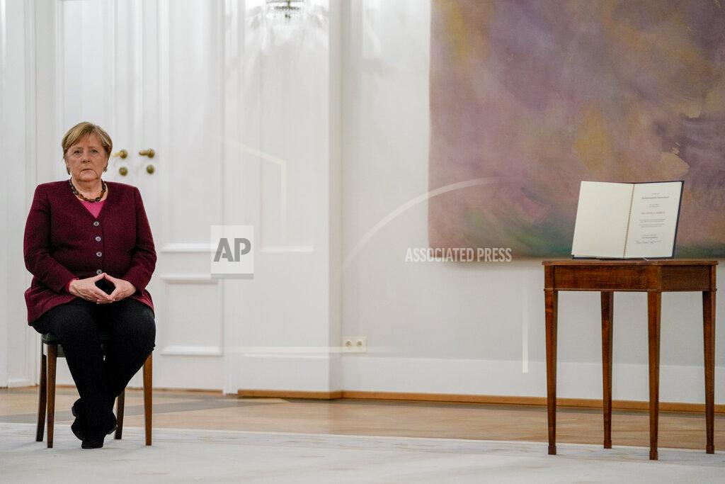 Markus Schreiber German Chancellor Angela Merkel waits for her certificate of dismissal, right, in Berlin, Tuesday, Oct. 26, 2021. Merkel stays in office until a successor is elected. (Photo/Markus Schreiber)