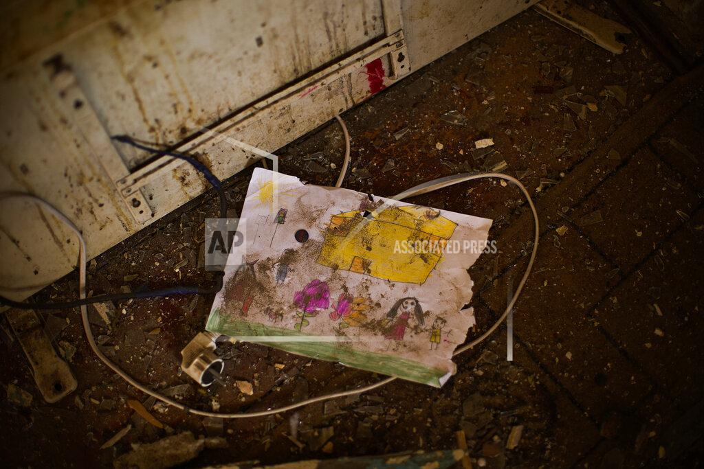 Francisco Seco A child's drawing lays on the floor of Iryna Martsyniuk's home, heavily damaged after a Russian bombing in Velyka Kostromka village, Ukraine, Thursday, May 19, 2022. Martsyniuk and her three young children were at home when the attack occurred in the village, a few kilometres from the front lines, but they all survived unharmed. (AP Photo/Francisco Seco)