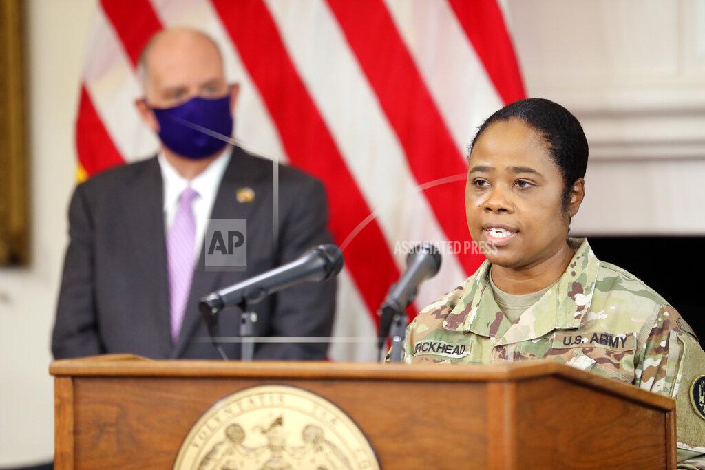 Brig. Gen. Janeen Birckhead, the Maryland National Guard's assistant adjutant general, outlines plans to improve equity in the distribution of COVID-19 vaccines in Maryland during a news conference in Annapolis, Md., on Thursday, March 4, 2021. Gov. Larry Hogan is standing left. (AP Photo/Brian Witte)