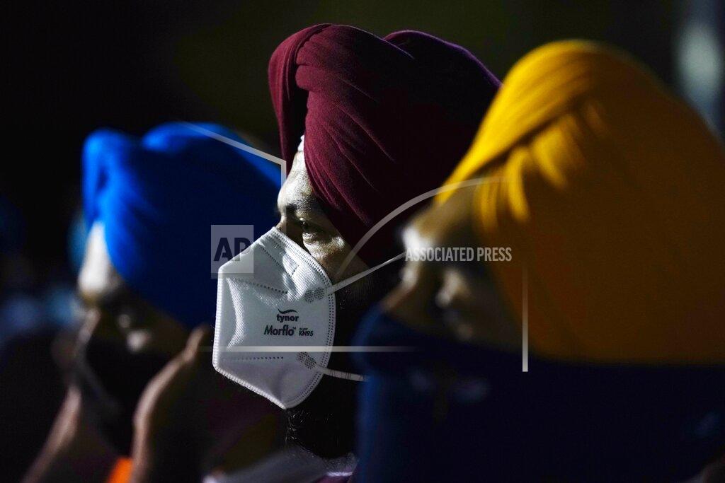 Ross D. Franklin Family and friends gather at a memorial service on the 20th anniversary of the murder of Balbir Singh Sodhi Wednesday, Sept. 15, 2021, in Mesa, Ariz. Sikh businessman Balbir Singh Sodhi was helping plant a flower bed at his Arizona gas station when he was shot dead by a man seeking to avenge 9/11. Mistaken for an Arab Muslim because of his turban and beard, Sodhi was the first person to die in a wave of bias crimes unleashed by the attacks. (AP Photo/Ross D. Franklin)