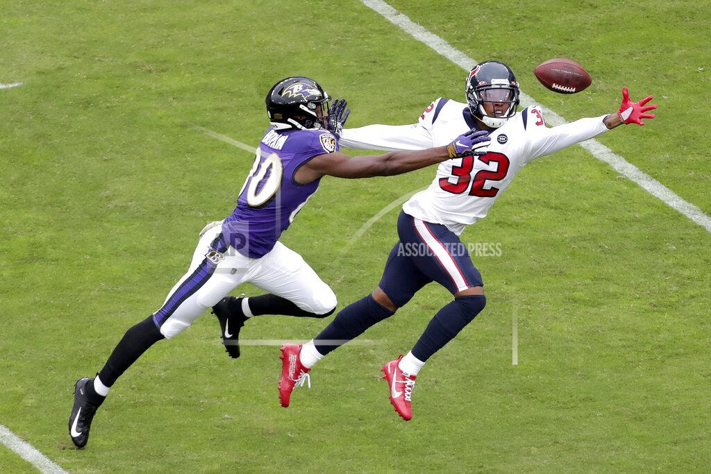 Julio Cortez Houston Texans cornerback Lonnie Johnson (32) and Baltimore Ravens wide receiver Miles Boykin (80) reach for a ball thrown by Ravens quarterback Lamar Jackson, not visible, during the first half of an NFL football game, Sunday, Nov. 17, 2019, in Baltimore. (AP Photo/Julio Cortez)