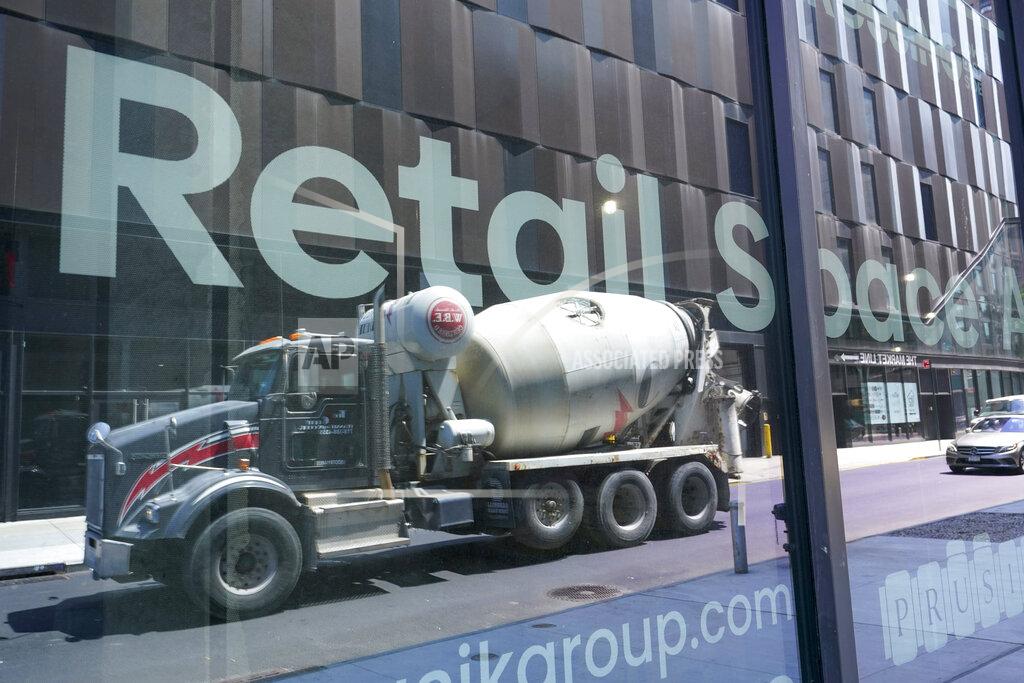 Mary Altaffer A cement mixer truck is reflected on a window of window advertising retail space for rent at a residential and commercial building under construction at the Essex Crossing development on the Lower East Side of Manhattan, Thursday, Aug. 4, 2022. On Friday, Aug. 5, the Labor Department delivers its July jobs report. (AP Photo/Mary Altaffer)