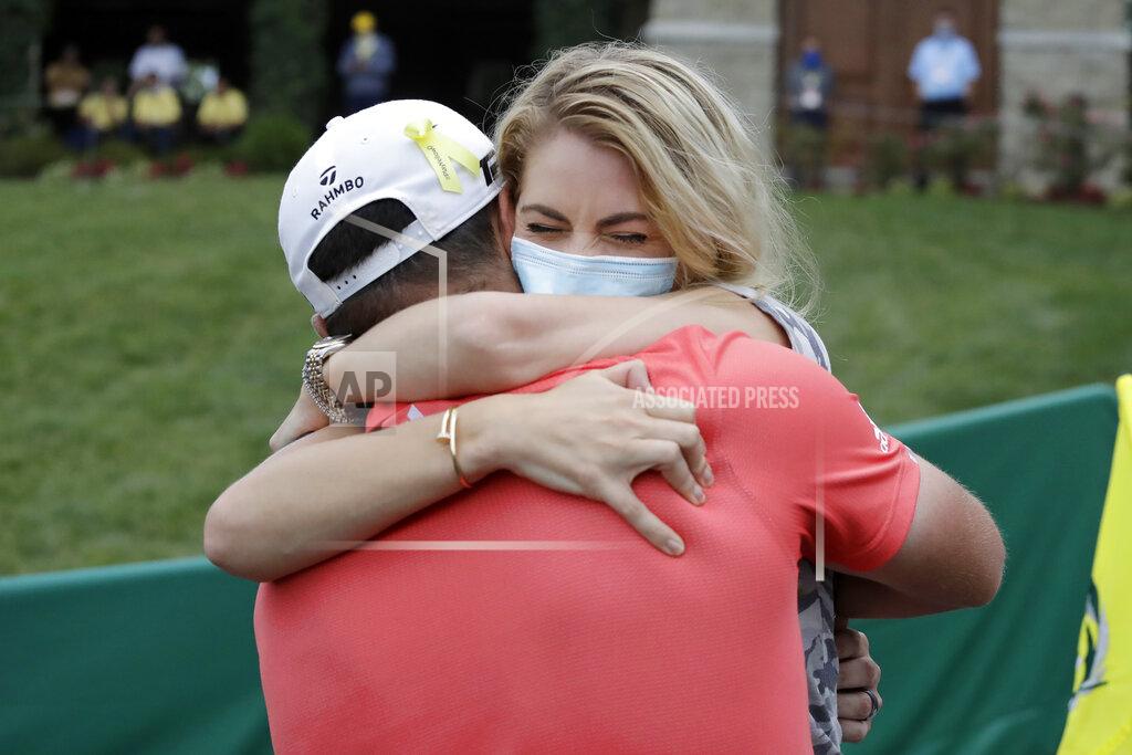 Darron Cummings Jon Rahm, of Spain, left, celebrates with his wife, Kelley Cahill, after winning the Memorial golf tournament, Sunday, July 19, 2020, in Dublin, Ohio. (AP Photo/Darron Cummings)