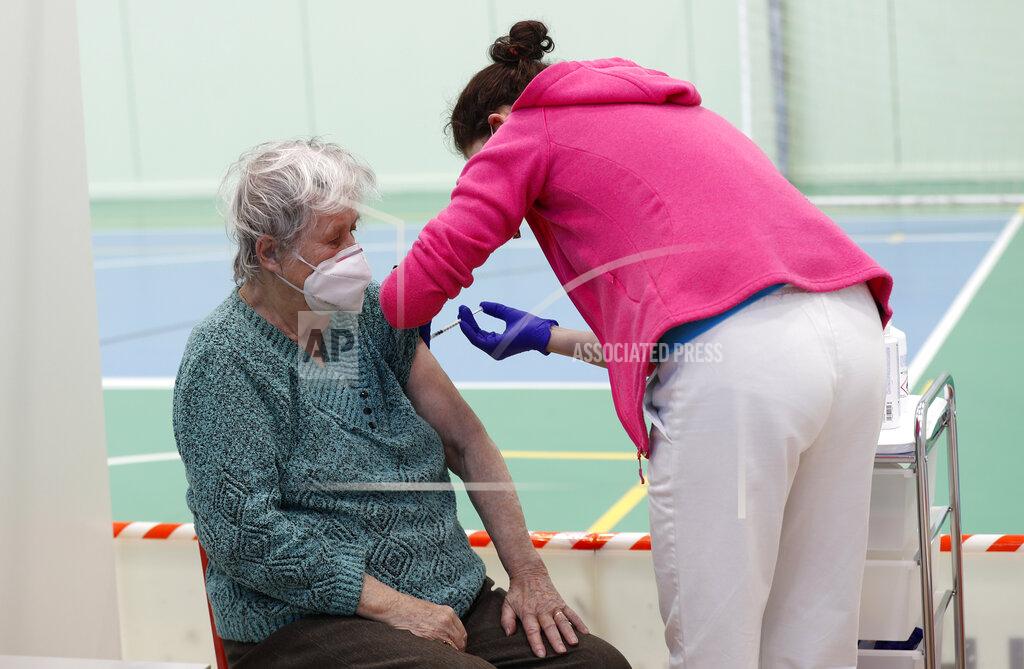 Petr David Josek An elderly woman receives Moderna COVID-19 vaccine at a sports hall in Ricany, Czech Republic, Friday, Feb. 26, 2021. With new infections soaring due to a highly contagious coronavirus variant and hospitals filling up, one of the hardest-hit countries in the European Union is facing inevitable: a tighter lockdown. (AP Photo/Petr David Josek)