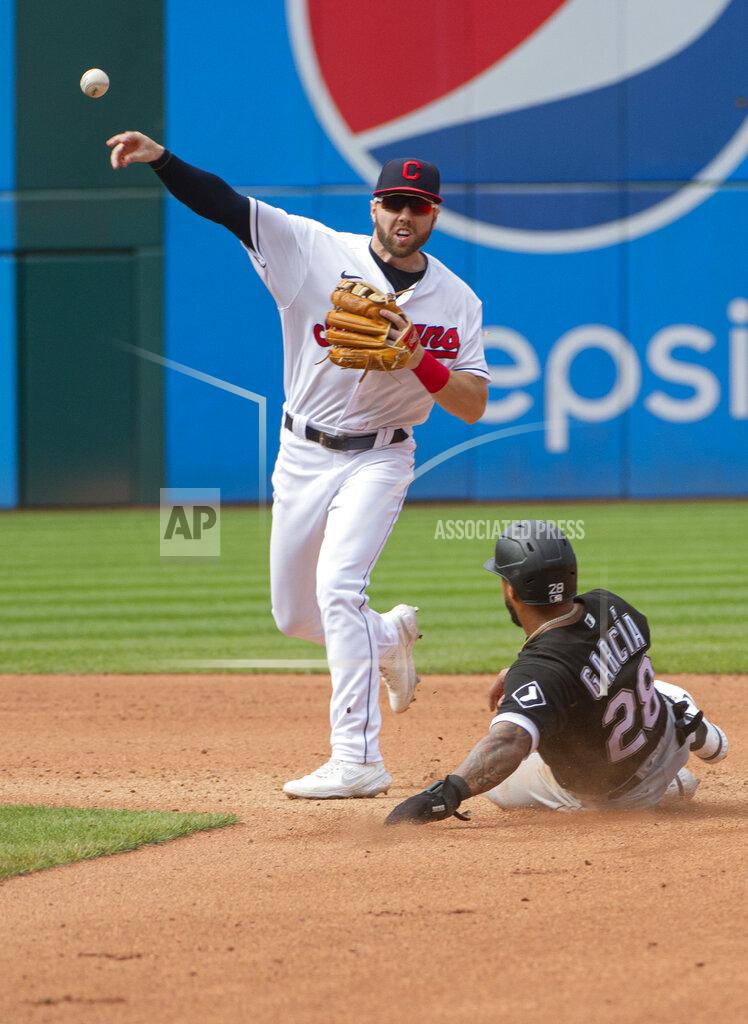 Phil Long Cleveland Indians' Owen Miller, left, throws to first base to complete a double play after forcing out Chicago White Sox's Leury Garcia, right, at second during the fourth inning of a baseball game in Cleveland, Sunday, Sept. 26, 2021. (AP Photo/Phil Long)