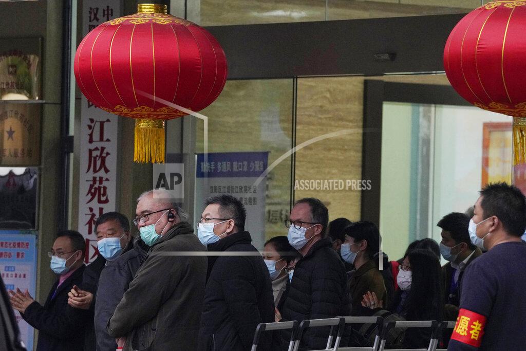 Ng Han Guan Peter Ben Embarek of the World Health Organization team, center, leaves after a field visit at the Service Center for Party Members and Residents of Jiangxinyuan Community in Wuhan, China, Thursday, Feb. 4, 2021. (AP Photo/Ng Han Guan)