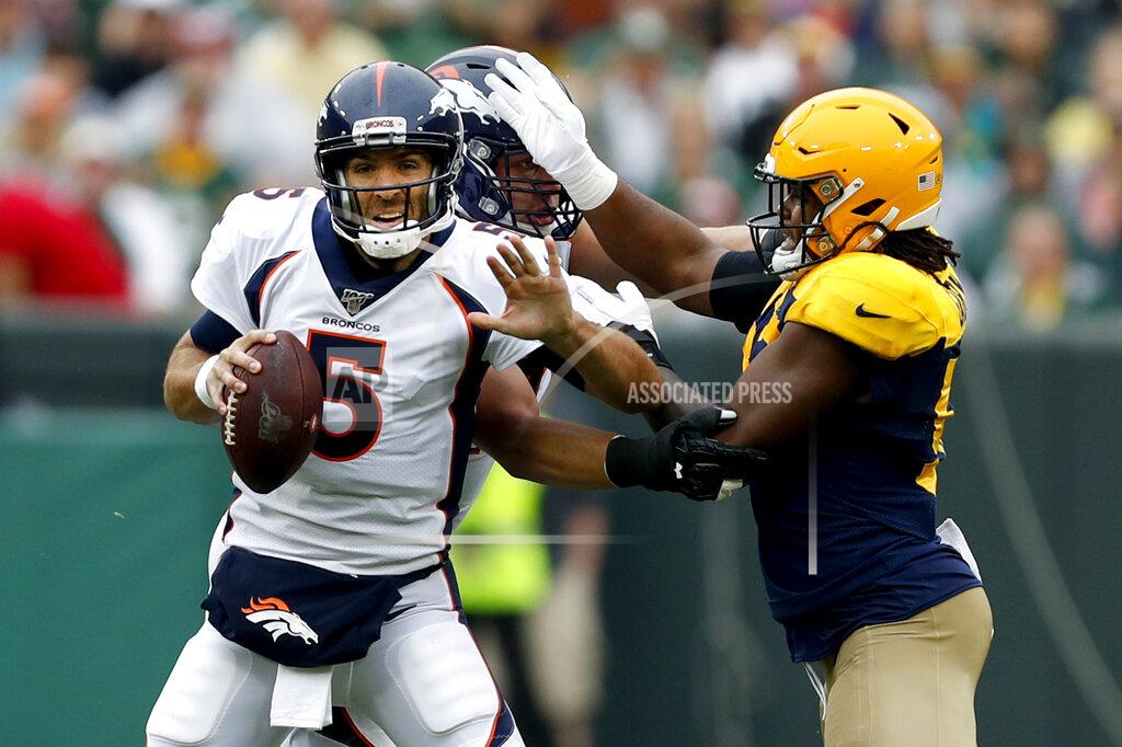 Matt Ludtke Denver Broncos quarterback Joe Flacco (5) tries to scramble away from Green Bay Packers linebacker Rashan Gary, right, during the first half of an NFL football game Sunday, Sept. 22, 2019, in Green Bay, Wis. (AP Photo/Matt Ludtke)