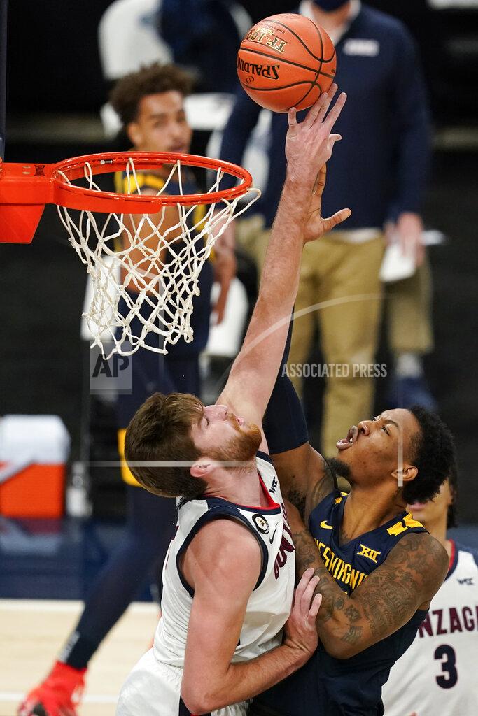 Darron Cummings West Virginia's Gabe Osabuohien (3) shoots against Gonzaga's Drew Timme, left, during the first half of an NCAA college basketball game Wednesday, Dec. 2, 2020, in Indianapolis. (AP Photo/Darron Cummings)