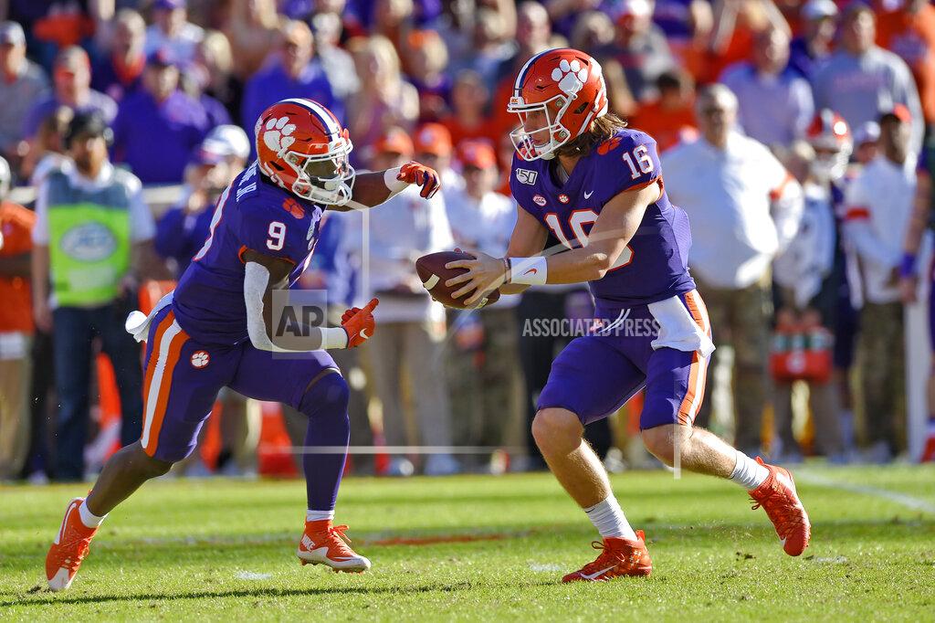 Richard Shiro Clemson quarterback Trevor Lawrence (16) hands the ball off to running back Travis Etienne (9) during the first half of an NCAA college football game against Wofford, Saturday, Nov. 2, 2019, in Clemson, S.C. (AP Photo/Richard Shiro)