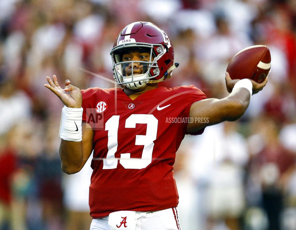 Butch Dill FILE - In this Saturday, Oct. 13, 2018, file photo, Alabama quarterback Tua Tagovailoa (13) throws a pass during the first half of the team's NCAA college football game against Missouri in Tuscaloosa, Ala. Alabama quarterback and Heisman Trophy front-runner Tua Tagovailoa aggravated a sprained right knee last week. The top-ranked Crimson Tide face Tennessee on Saturday. (AP Photo/Butch Dill, File)
