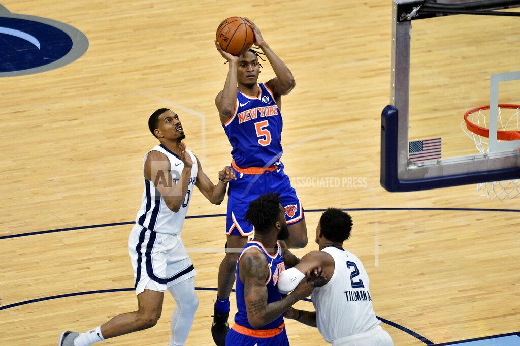 Brandon Dill New York Knicks guard Immanuel Quickley (5) shoots ahead of Memphis Grizzlies guard De'Anthony Melton (0) in the second half of an NBA basketball game Monday, May 3, 2021, in Memphis, Tenn. (AP Photo/Brandon Dill)