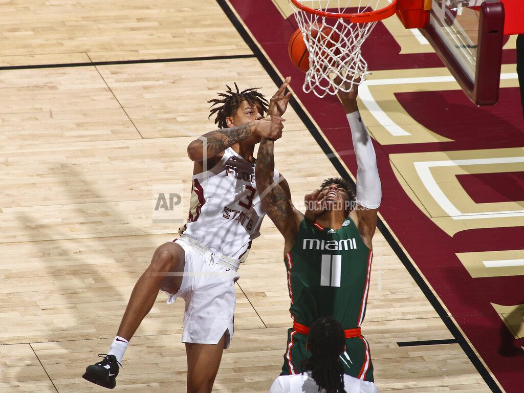 Phil Sears Florida State forward Cameron Corhen (3) fouls Miami guard Jordan Miller (11) in the first half of an NCAA college basketball game in Tallahassee, Fla., Tuesday, Jan. 24, 2023. (AP Photo/Phil Sears)