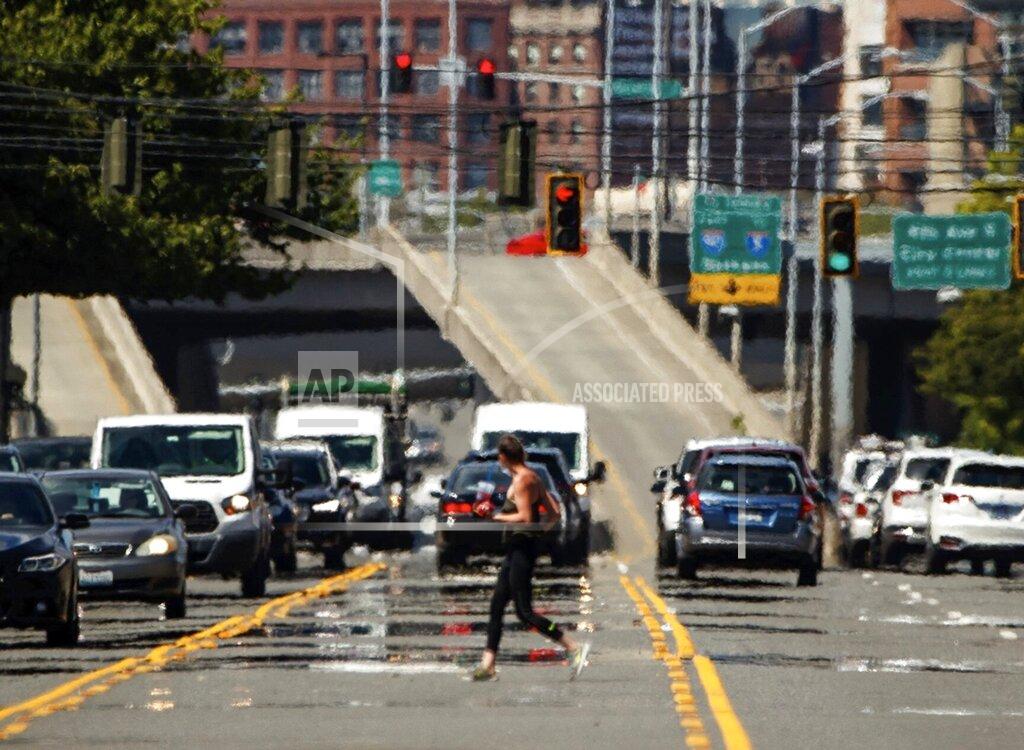 Amanda Snyder Heat waves distort a street scene in the Sodo neighborhood of Seattle on Wednesday., June 23, 2021. It's been an unseasonably hot June in the Seattle area, and warmer temperatures are on the way, forecast to last into next week. (Amanda Snyder/The Seattle Times via AP)