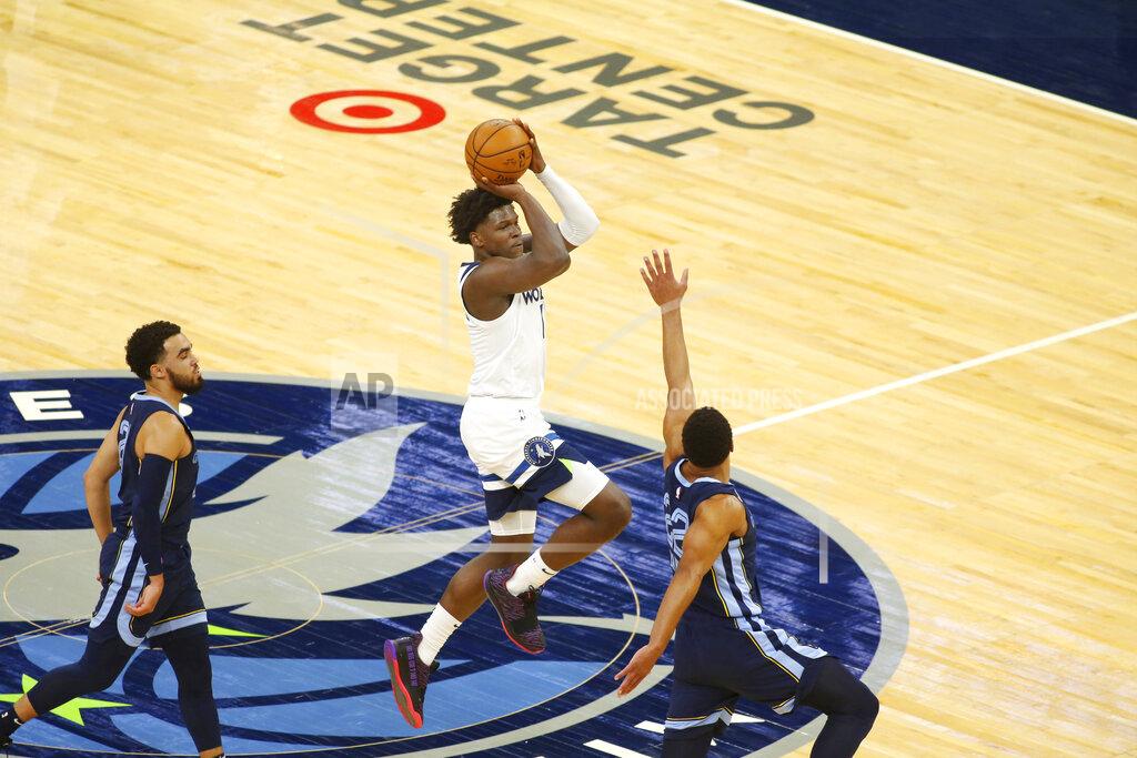 Andy Clayton-King Minnesota Timberwolves guard Anthony Edwards shoots at the end of the first quarter against Memphis Grizzlies defenders Tyus Jones (21) and Desmond Bane in the third quarter during an NBA preseason basketball game, Saturday, Dec. 12, 2020, in Minneapolis. (AP Photo/Andy Clayton- King)