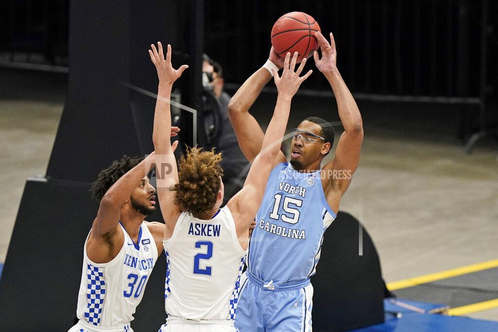 Tony Dejak North Carolina's Garrison Brooks (15) looks to pass against Kentucky's Olivier Sarr (30) and Devin Askew (2) in the second half of an NCAA college basketball game, Saturday, Dec. 19, 2020, in Cleveland. North Carolina won 75-63. (AP Photo/Tony Dejak)