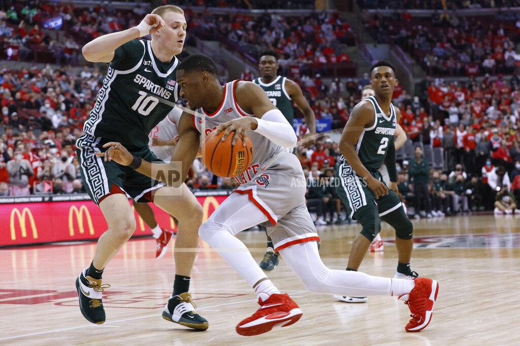 Jay Laprete Ohio State's Malaki Branham, front, drives the baseline against Michigan State's Joey Hauser during the second half of an NCAA college basketball game Thursday, March 3, 2022, in Columbus, Ohio. (AP Photo/Jay LaPrete)